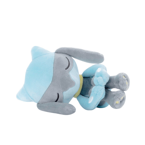 Coussin Riolu en peluche bleu clair et gris, avec de longues oreilles, des détails jaunes et des yeux brodés.