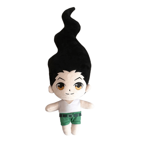 Gon peluche, personnage en tissu aux cheveux noirs dressés, aux grands yeux bruns et vêtu d’un haut blanc et d’un short vert.