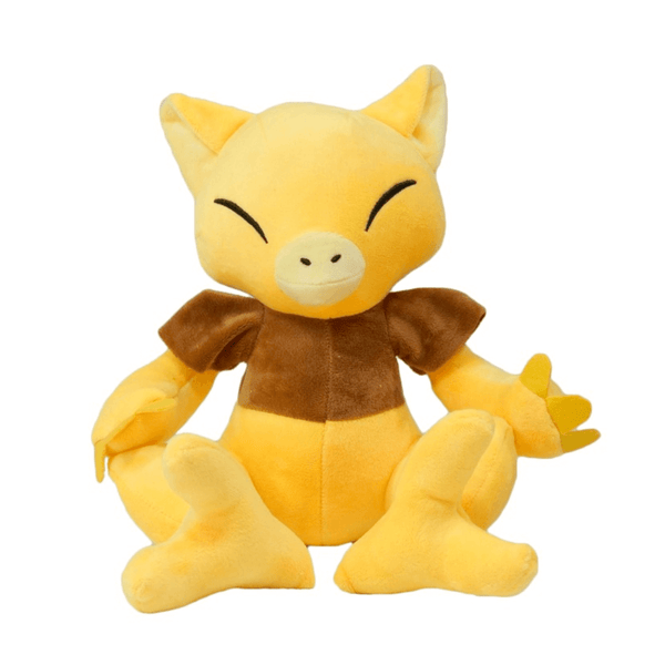 peluche Abra jaune et brune en tissu doux, avec de grandes oreilles, un museau rond et des yeux fermés