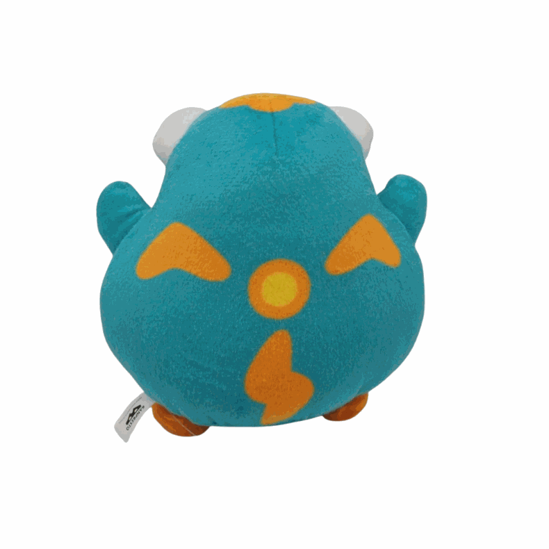 peluche Ampibidou turquoise en tissu doux, avec des motifs orange et des oreilles grises, au corps rond