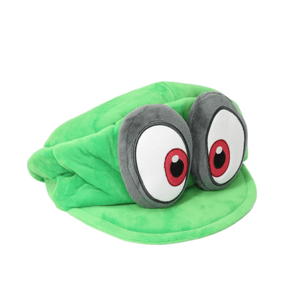 Peluche Cappy en tissu vert, ornée de deux grands yeux expressifs aux iris rouges et noirs.