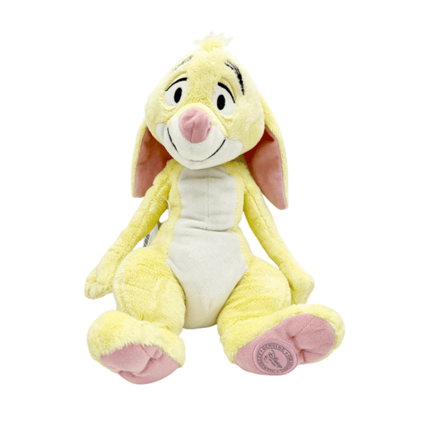 Peluche Coco Lapin jaune pâle et crème, aux longues oreilles roses, au nez rose et aux pieds rembourrés.