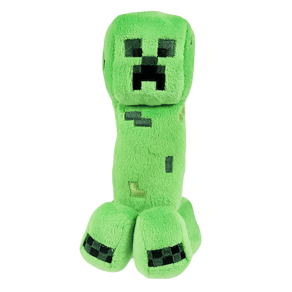 Peluche Creeper verte en peluche douce, avec visage pixelisé noir et quatre pattes ornées de carrés sombres.