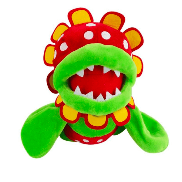Peluche Flora Piranha verte et rouge en tissu doux, à pois blancs, avec une large gueule garnie de dents et des pétales jaunes.