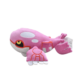 Peluche Kyogre Shiny rose et blanche, en tissu doux, avec des motifs rouges, de grands yeux et des nageoires détaillées.