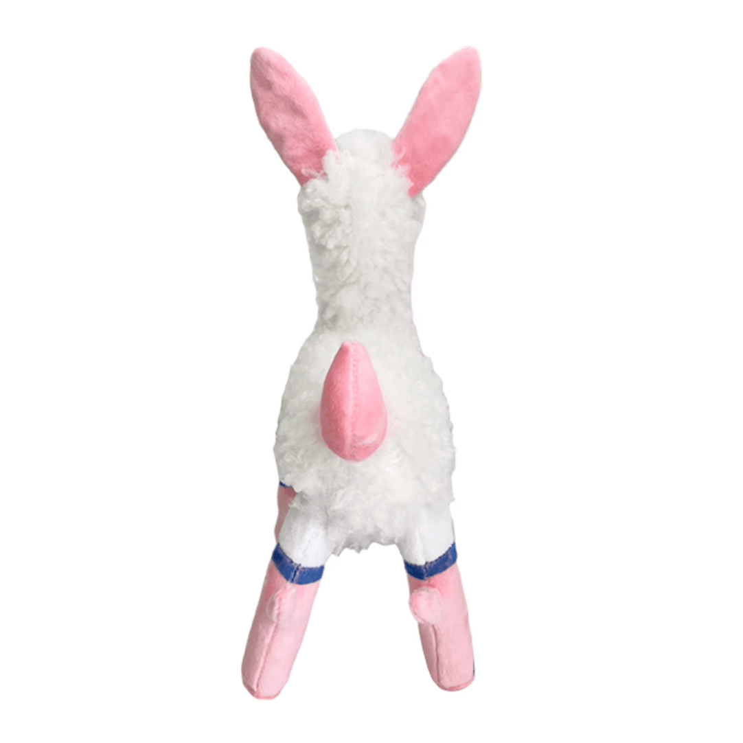 Peluche Melpaca blanche en matière douce et duveteuse, avec de longues oreilles, une queue rose et des pattes roses et bleues.