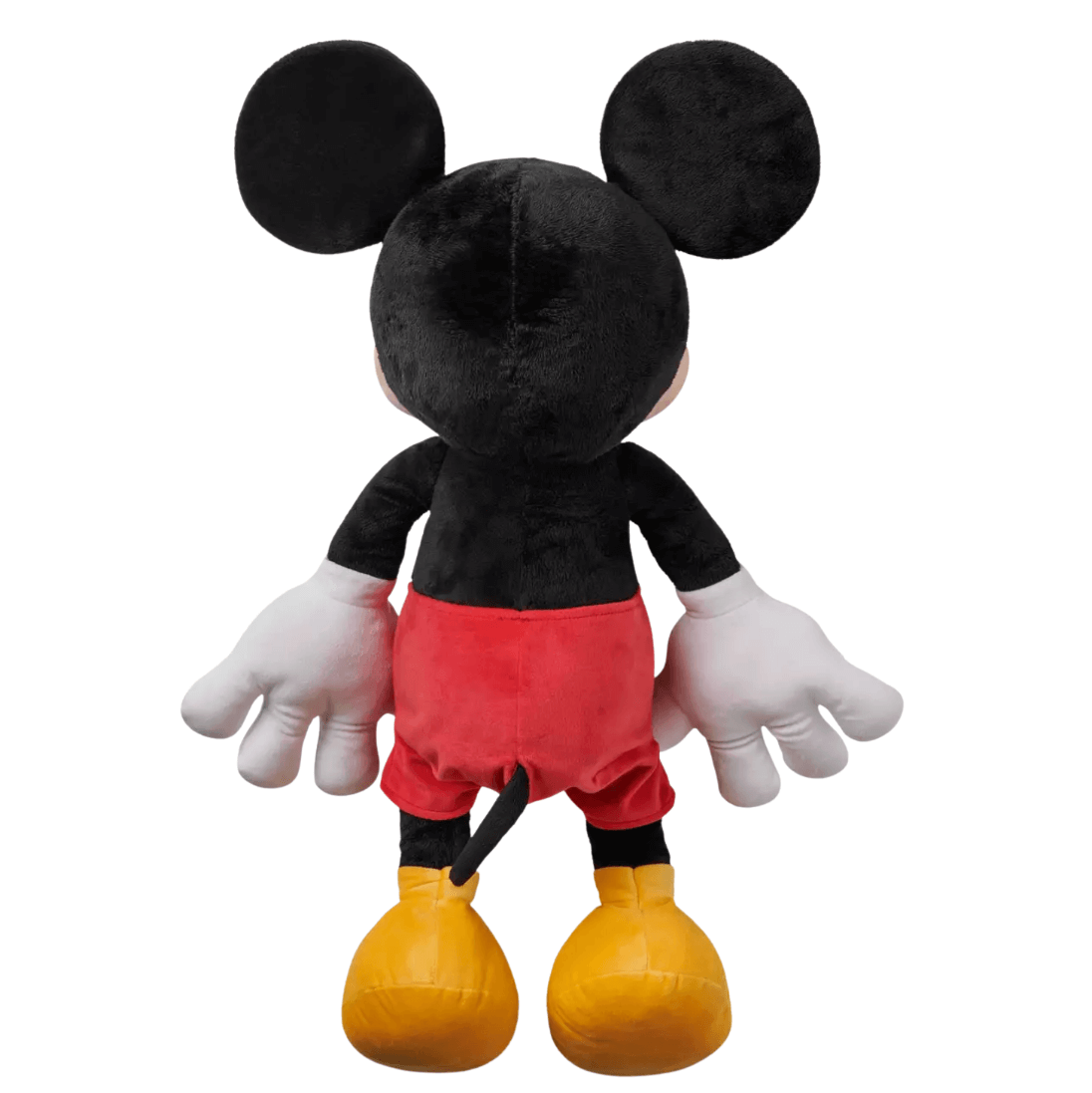 Peluche Mickey Mouse en tissu noir doux, vue de dos, avec un short rouge, des gants blancs et de grandes chaussures jaunes.