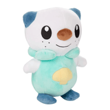 Peluche Moustillon blanc et turquoise, en tissu doux, avec coquillage jaune sur le ventre et oreilles bleues
