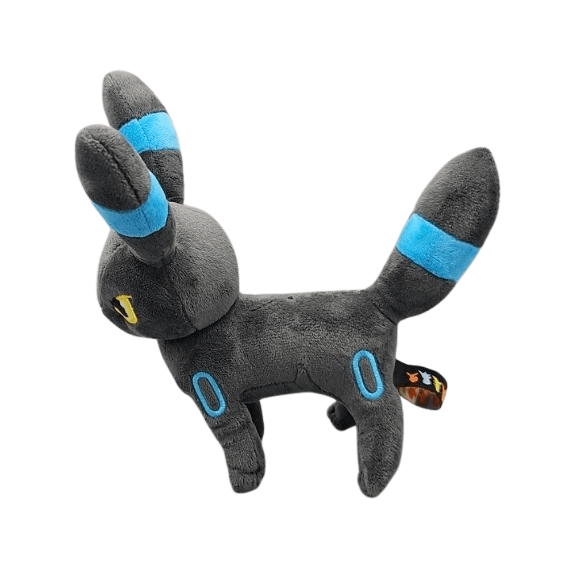 Peluche Noctali Shiny gris foncé en tissu doux, avec des anneaux bleus et des bandes cyan sur les oreilles et la queue