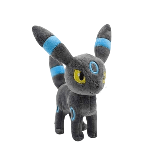 Peluche Noctali Shiny grise en tissu doux, avec des anneaux et des bandes bleu vif, des yeux jaunes et de grandes oreilles.