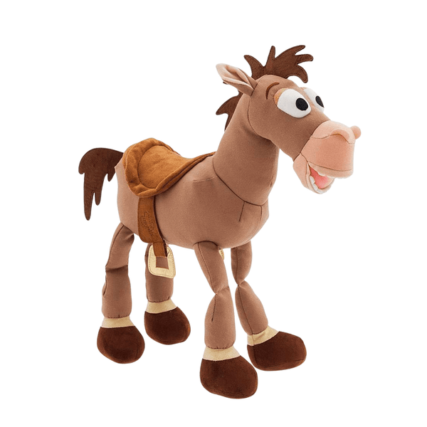 Peluche Pil Poil en tissu marron, avec crinière brune, museau rose, selle et grands yeux expressifs