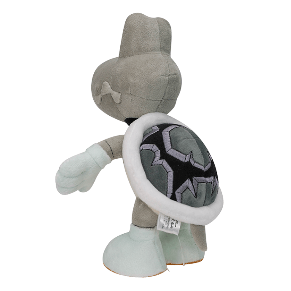 Peluche Skelerex grise et beige, avec une carapace noire ornée de motifs géométriques violets et gris.
