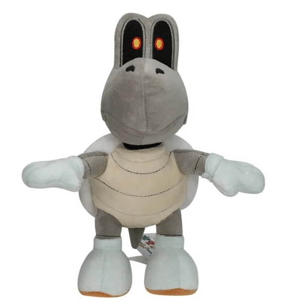 Peluche Skelerex grise et beige, avec yeux rouges, longue tête osseuse et membres aux extrémités bleu pâle.