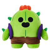 Peluche Spike verte en tissu doux, avec des épines, des fleurs orange sur la tête et un short brun.