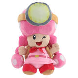 Peluche Toadette rose et beige, avec une grande coiffe à pois, une visière jaune et grise et un nœud rouge.