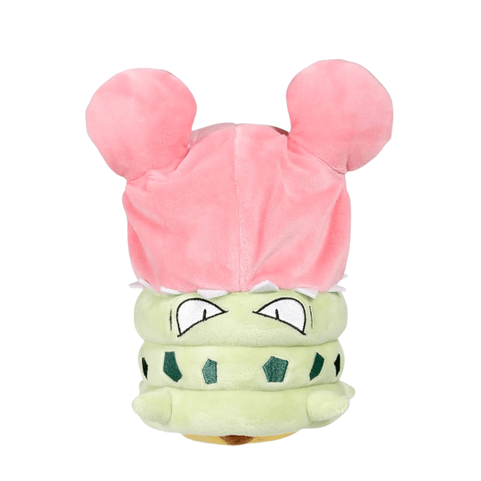 Peluches Pokémon représentant Pikachu en cosplay de Méga-Flagadoss, avec une coquille rose et un visage vert pâle.